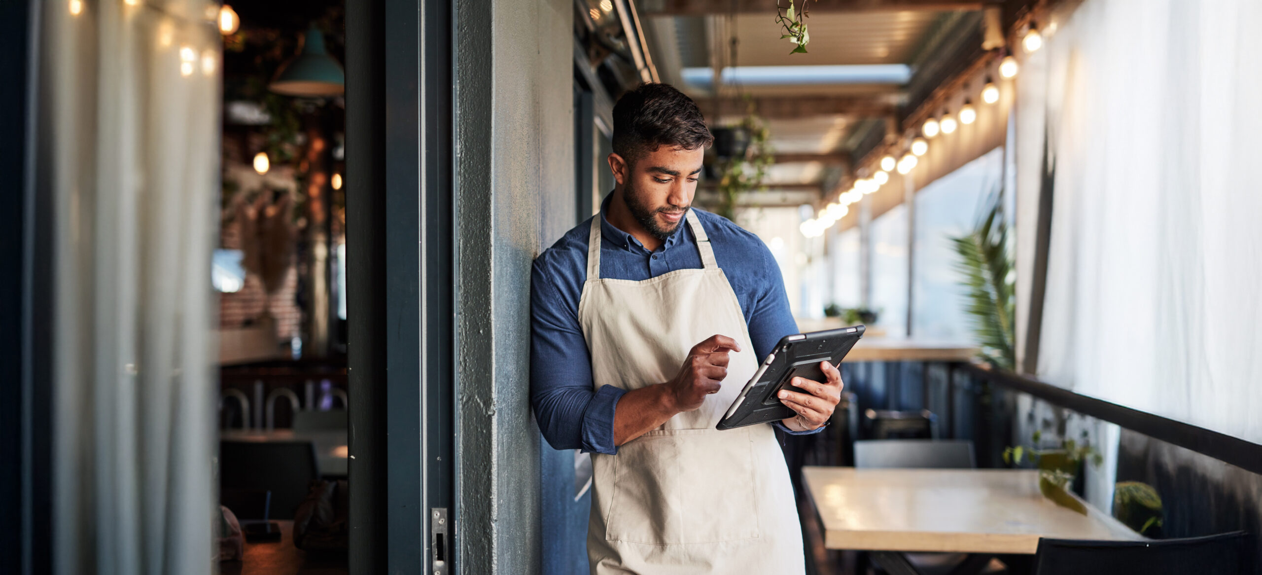 Small Business owner reviewing OSHA recordables on tablet