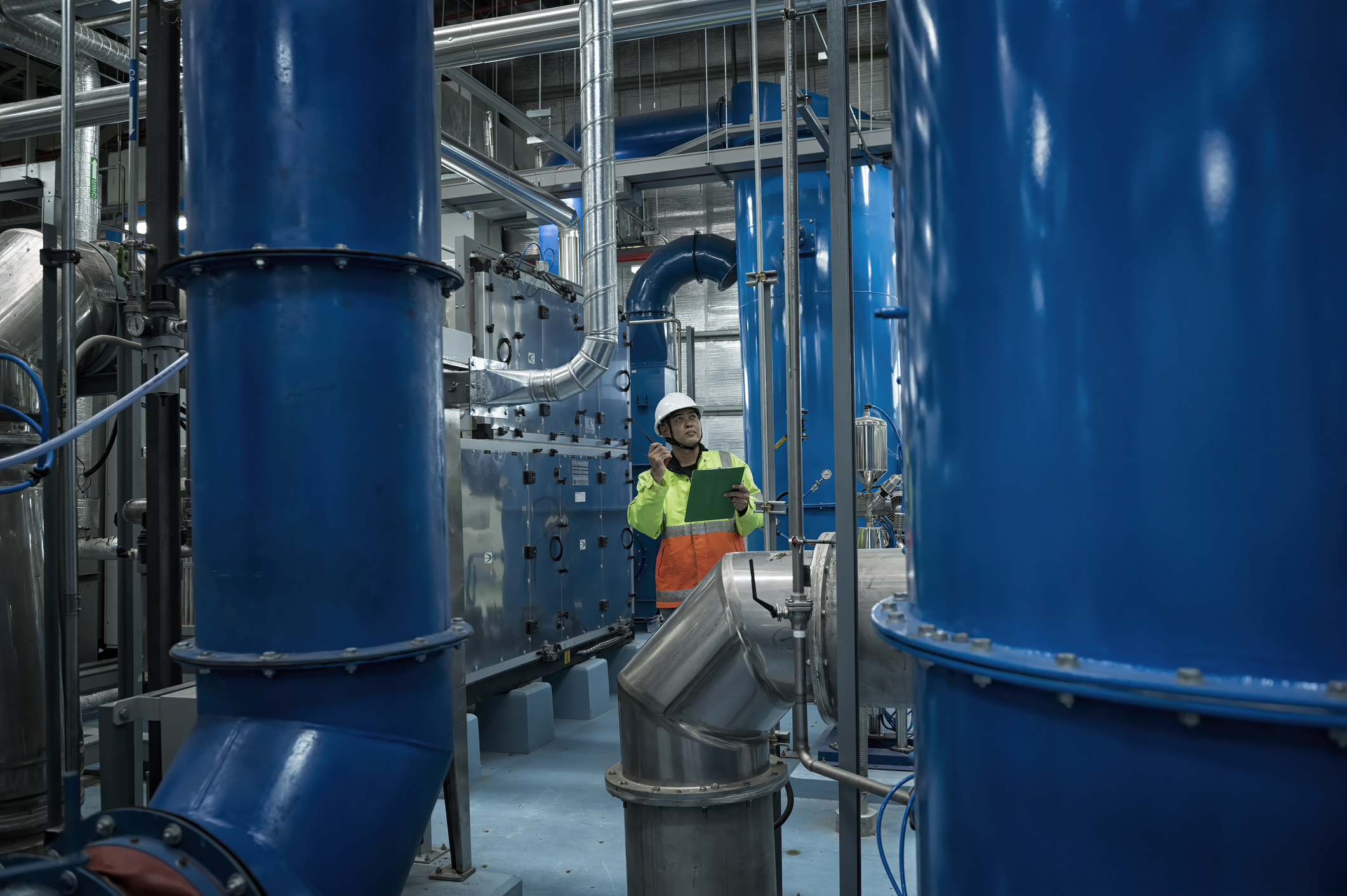 Engineer inspecting industrial pipes